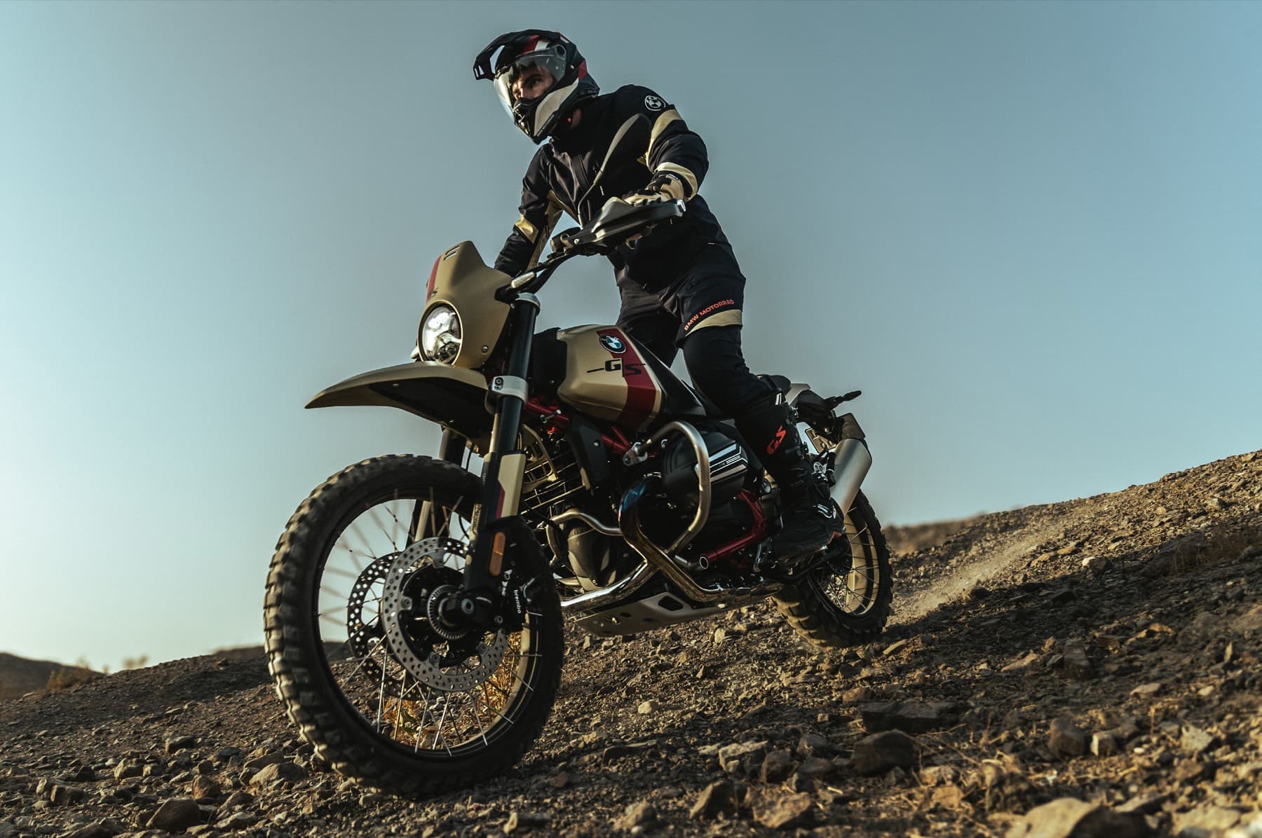 Rider climbing a rocky slope on a BMW GS