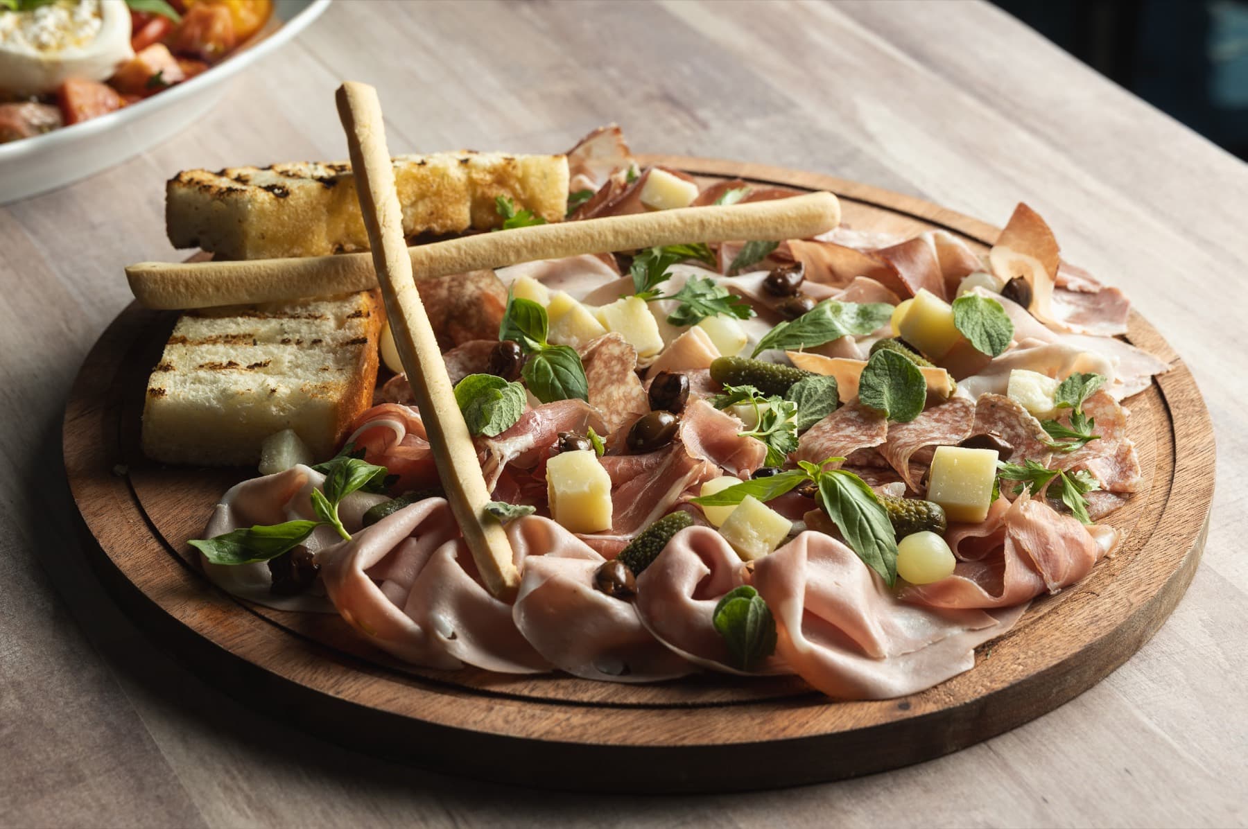 Charcuterie board with cured meats and herbs