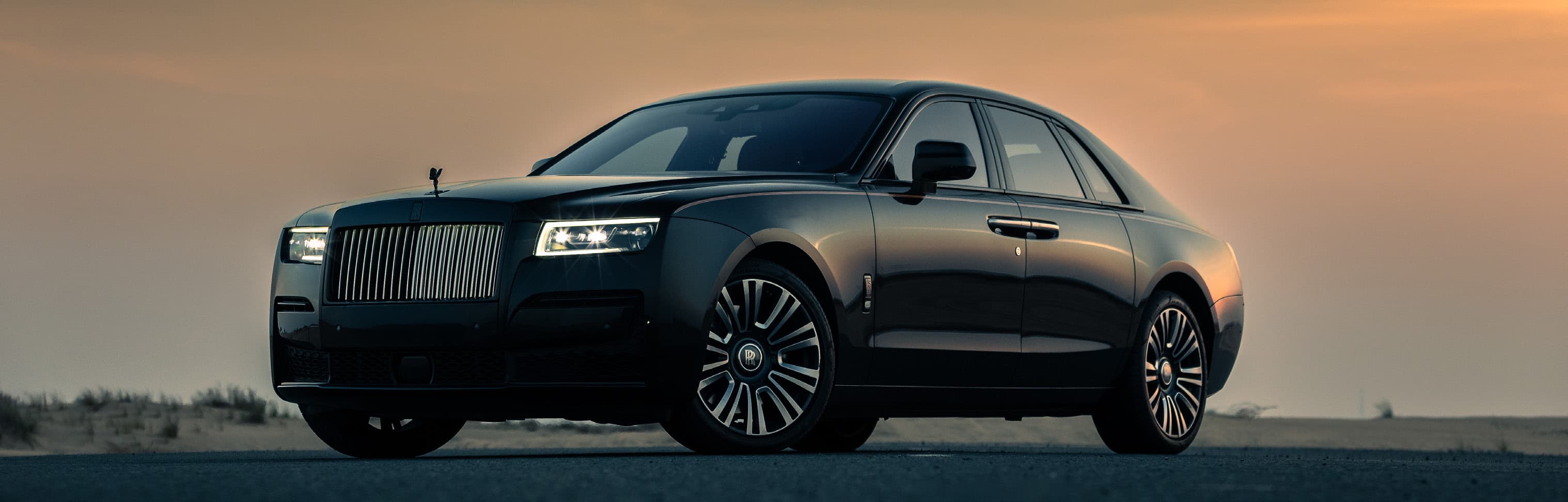 Rolls-Royce Ghost against a desert sunset